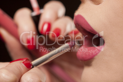 beautician applying lipstick to a model