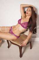 sexy woman in lingerie reclining on a chair