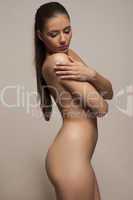 beautiful demure young woman posing nude