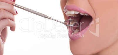 woman with a dental mirror displaying her teeth