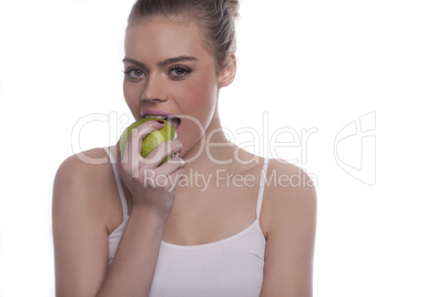 beautiful healthy woman enjoying a green apple