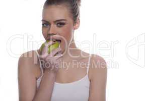 beautiful healthy woman enjoying a green apple