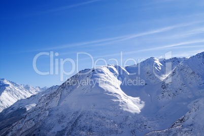 snowy sunlight mountains, view from off piste slope