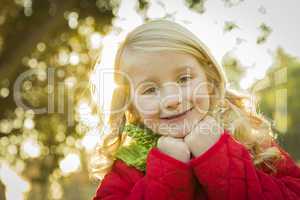 little girl wearing winter coat and scarf at the park.