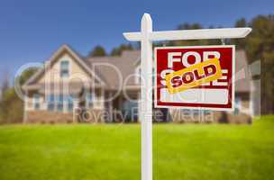 sold home for sale sign in front of new house