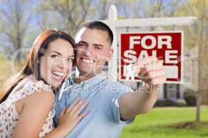 military couple in front of home, house keys and sign