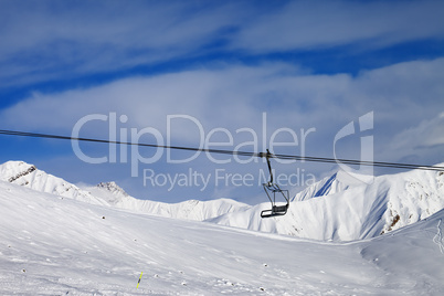 chair lift and off-piste slope at nice day