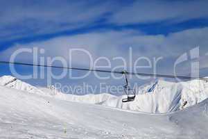 chair lift and off-piste slope at nice day