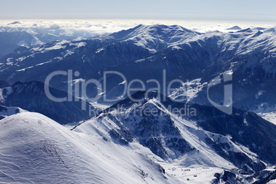 snowy mountains and off-piste slope in morning haze