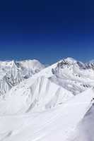 off-piste slope and blue clear sky in sun day