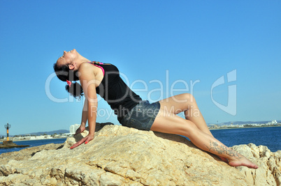 girl on the rocks by the sea