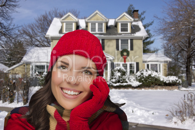 smiling mixed race woman in winter clothing outside in snow