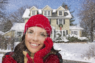 smiling mixed race woman in winter clothing outside in snow