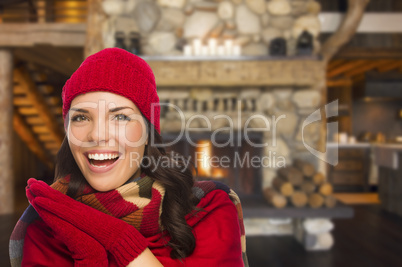 mixed race girl enjoying warm fireplace in rustic cabin