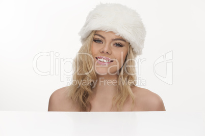 beautiful smiling blond woman in a fur hat