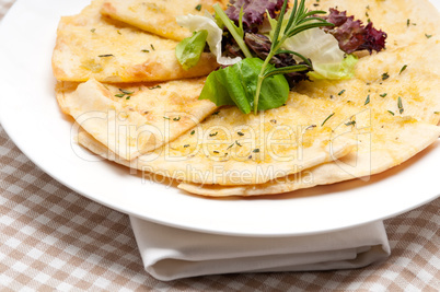 garlic pita bread pizza with salad on top