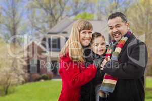 happy mixed race family in front of house