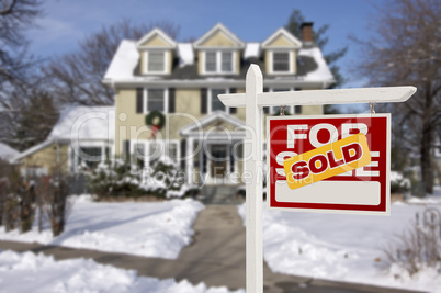 sold home for sale sign in front of new house