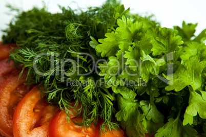 cut pieces of tomatoes and dill and parsley