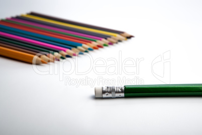 row of colored pencils and simple pencil