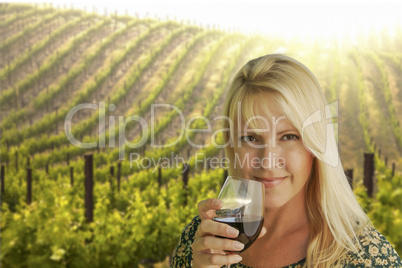 attractive woman enjoying a glass of wine at the vineyard