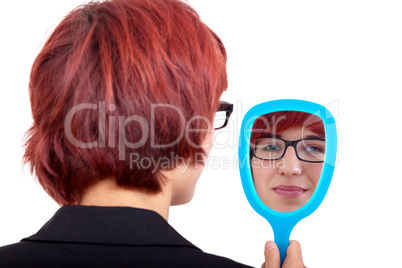 woman looking in the hand mirror