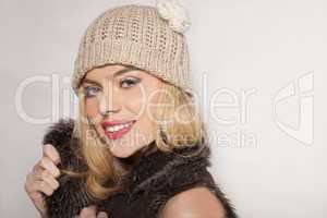 attractive blond in a winter jacket and beanie