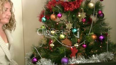 woman decorating the christmas tree