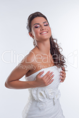 Portrait of happy beautiful bride corrects dress