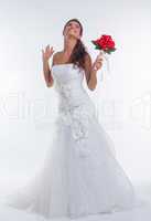 Cheerful bride posing with bouquet of red flowers