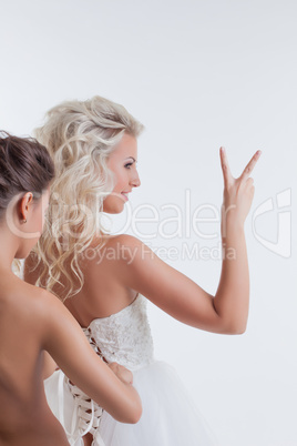 Portrait of bride posing showing gesture, close-up