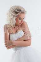 Shy beautiful bride posing in studio, close-up