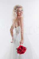 Cheerful blonde posing in stylish wedding dress