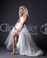 Image of sensual young bride shows garter on leg