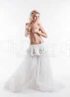 Sensual topless bride posing in stylish dress