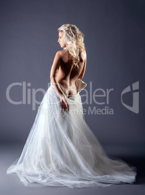 Sexy slim bride posing back to camera