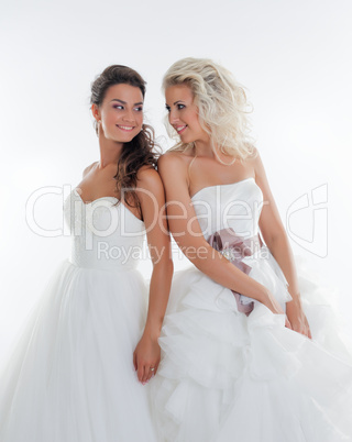 Beautiful young brides smiling at each other