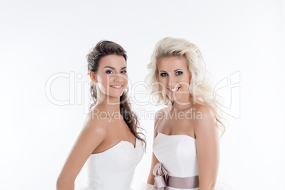 Portrait of smiling women in wedding dresses