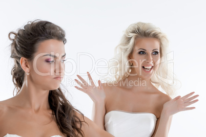 Portrait of emotional brides posing in studio