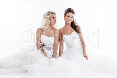 Two smiling young brides isolated on white