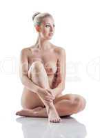 Adorable blonde sitting nude in studio