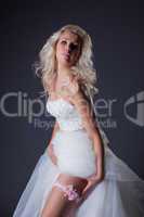 Seductive blonde posing in chic wedding dress