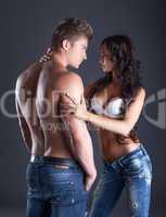 Emotional young couple posing in fashionable jeans