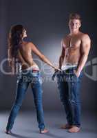 Image of attractive young couple posing in jeans