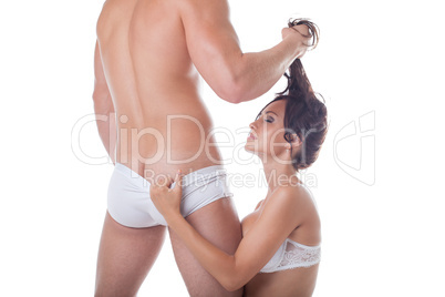 Muscular man and sexy girl kneeling before him