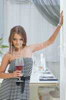 Artfully smiling young girl posing in restaurant