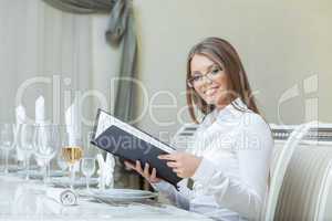 Smiling charming woman posing with menu, close-up