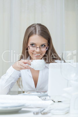 Business woman drinking coffee in restaurant