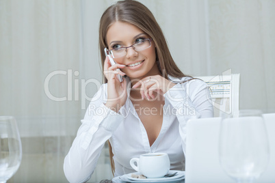 Beautiful business woman talking on mobile phone