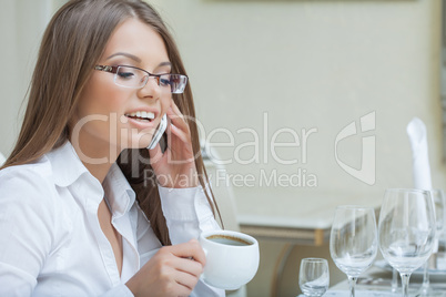 Portrait of smiling young woman talking on cell